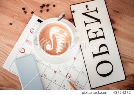 Cup of coffee standing on the calendar Cup of coffee standing on the calendar 45714272