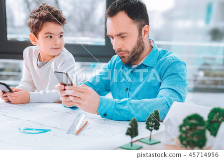 Cute boy looking at his dad Cute boy looking at his dad 45714956