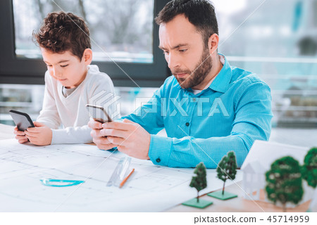 Father and son playing on the phone 45714959