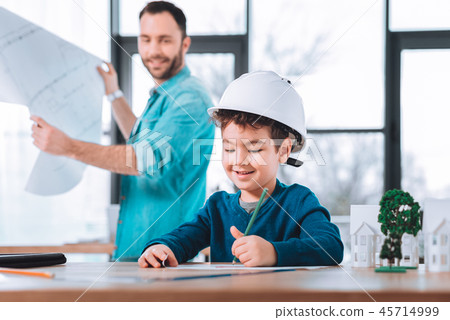 Motivated child drawing in an office 45714999