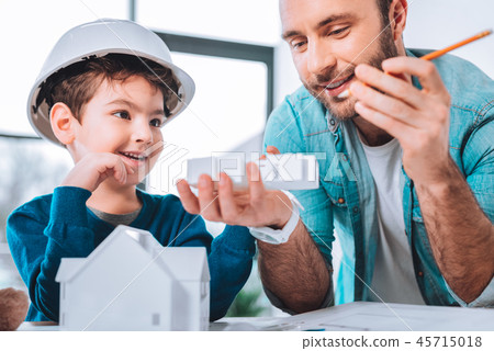 Handsome man taking care of his son 45715018