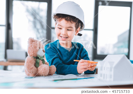 Cute child looking at the teddy bear 45715733
