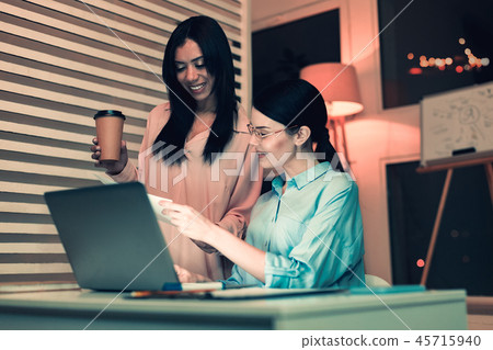 Smart woman helping her colleague Smart woman helping her colleague 45715940