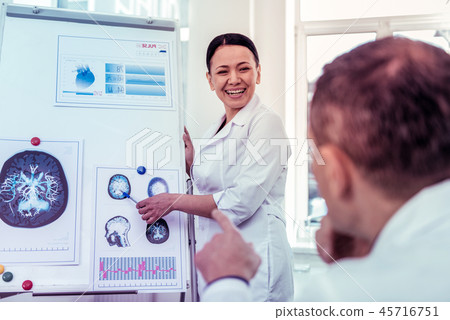 Happy Asian medical worker presenting results of research Happy Asian medical worker presenting results of research 45716751