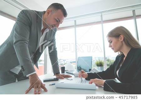 Female showing her boss real estate building plan Female showing her boss real estate building plan 45717985