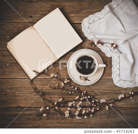 cup coffee white saucer book wooden background 45718261