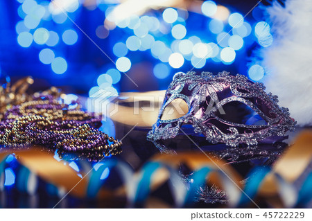 Traditional female carnival venetian mask on bokeh background. Masquerade, Venice, Mardi Gras Traditional female carnival venetian mask on bokeh background. Masquerade, Venice, Mardi Gras 45722229