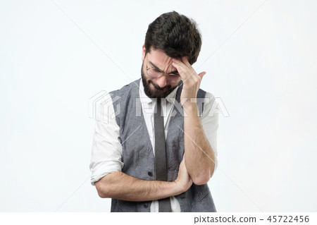 Puzzled young hispanic man on gray background Puzzled young hispanic man on gray background 45722456
