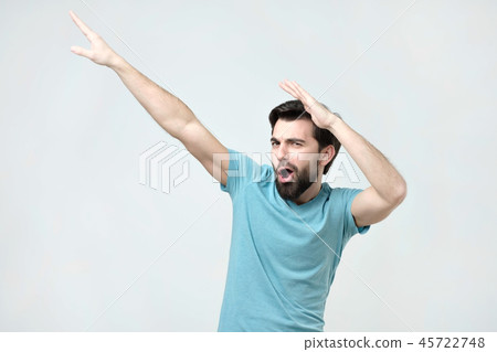 Young happy hispanic man in blue t-shirt dancing. Young happy hispanic man in blue t-shirt dancing. 45722748