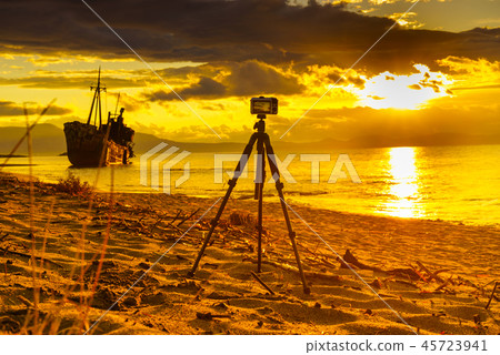 Camera on tripod and shipwreck Camera on tripod and shipwreck 45723941
