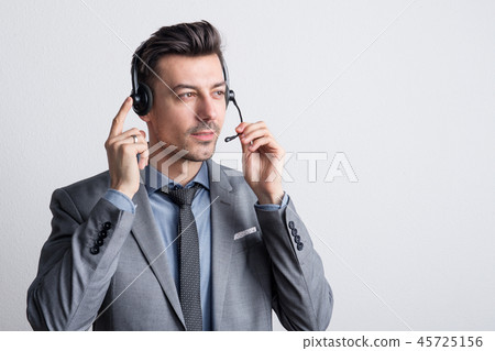 Portrait of a young man with headset in a studio. Copy space. 45725156