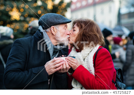 Senior couple on an outdoor Christmas market. 45725827