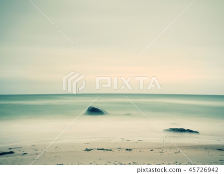 Sand of beach with soft waves and pebbles, morning Sand of beach with soft waves and pebbles, morning 45726942
