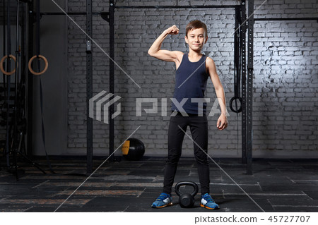 Training and sport. Kid in crossfit gym. Healthy lifestyle. 45727707