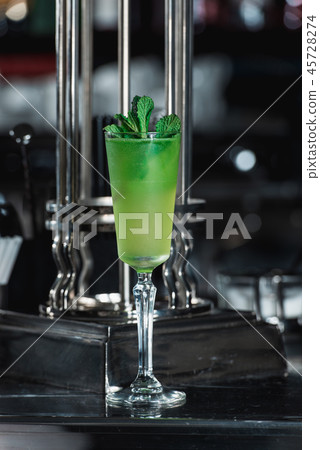 Green refreshing Alcoholic Cocktail. Mint on top 45728274