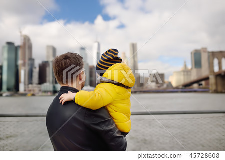 Father and son looking at skyscrapers of Manhattan 45728608