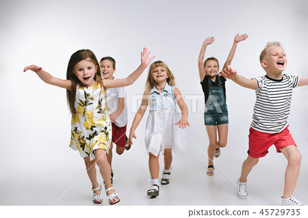 Group fashion cute preschooler kids friends posing together and looking at camera white background 45729735
