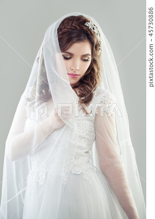 Bride woman wearing white bridal dress and veil Bride woman wearing white bridal dress and veil 45730886