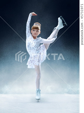 Little girl figure skating at the indoor ice arena. Little girl figure skating at the indoor ice arena. 45731971