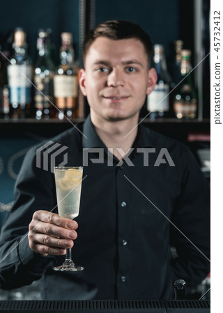 bartender offering French 75 Cocktail. Bar on a background 45732412