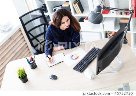 A young girl working with documents on the computer. 45732730