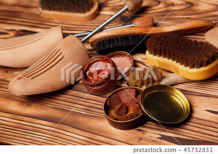 Shoe care shoetree, brushes, cream,wax on table. 45732831