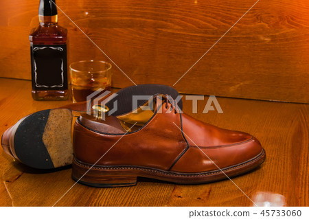 bottle of whiskey luxury shoes polished. bottle of whiskey luxury shoes polished. 45733060