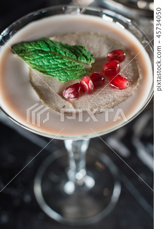 Espresso Martini cocktail, grains of pomegranate on top 45734050