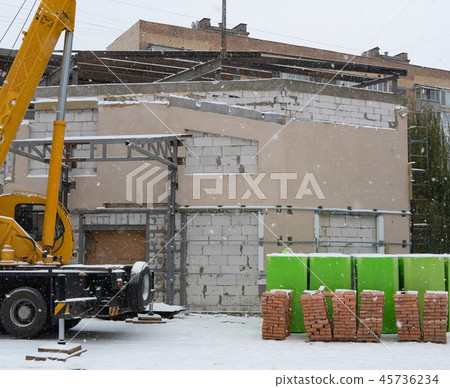 construction site small crane pallets red bricks 45736234