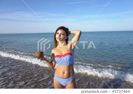 a beautiful woman in a bathing suit in the winter in the South a beautiful woman in a bathing suit in the winter in the South 45737464