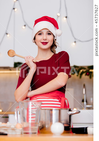 housewife in Santa Claus hat cooking Christmas dinner housewife in Santa Claus hat cooking Christmas dinner 45737627