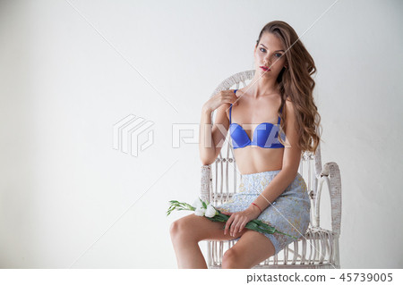 Portrait of beautiful fashionable women in underwear in the bedroom on a white Chair 45739005