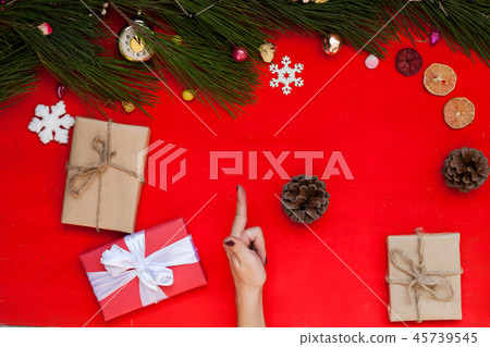women's hands at the Christmas background Christmas tree holiday new year gifts women's hands at the Christmas background Christmas tree holiday new year gifts 45739545