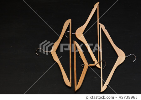 old wooden hangers for fashionable things on the background 45739963