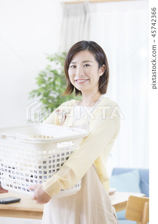 A young housewife doing housework A young housewife doing housework 45742366
