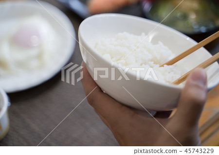 Hand of Japanese man eating breakfast 45743229