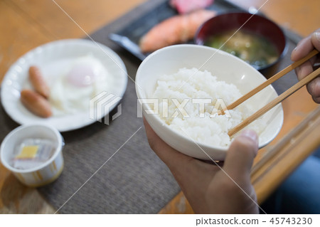 Hand of Japanese man eating breakfast Hand of Japanese man eating breakfast 45743230