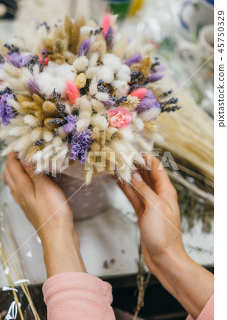 The process of making a bouquet. Colorful bouquet of different dried flowers deadwood flowers in the The process of making a bouquet. Colorful bouquet of different dried flowers deadwood flowers in the 45750329