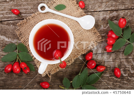 tea with rose hips on old wooden background. Top view tea with rose hips on old wooden background. Top view 45750648