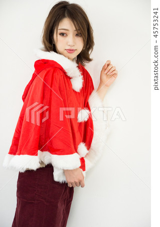 Woman wearing a santa cape Woman wearing a santa cape 45753241
