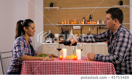 Happy loving couple is having romantic dinner at home. Happy loving couple is having romantic dinner at home. 45753489