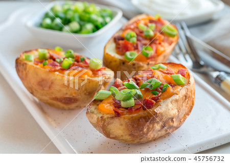 Baked potato skins with cheddar cheese and bacon Baked potato skins with cheddar cheese and bacon 45756732