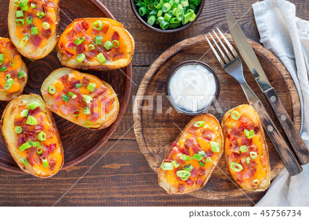 Baked potato skins with cheddar cheese and bacon Baked potato skins with cheddar cheese and bacon 45756734