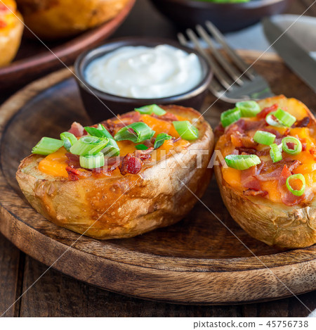 Baked potato skins with cheddar cheese and bacon Baked potato skins with cheddar cheese and bacon 45756738