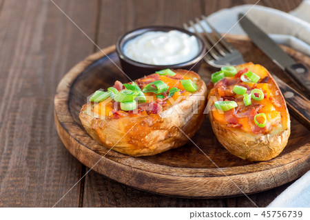 Baked potato skins with cheddar cheese and bacon Baked potato skins with cheddar cheese and bacon 45756739