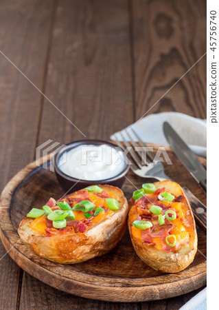 Baked potato skins with cheddar cheese and bacon Baked potato skins with cheddar cheese and bacon 45756740