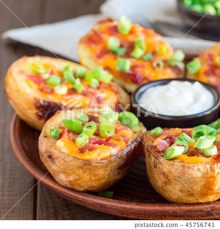 Baked potato skins with cheddar cheese and bacon Baked potato skins with cheddar cheese and bacon 45756741