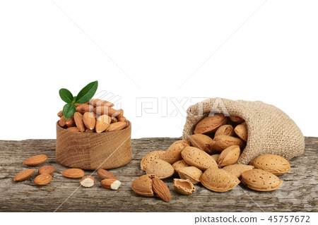 Almonds with leaf in bag from sacking on a wooden table with a white background 45757672