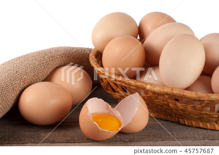 eggs on a wooden table in a wicker basket on a white background 45757687
