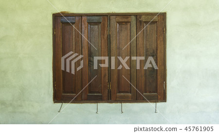 Old wooden windows frame on cement wall 45761905